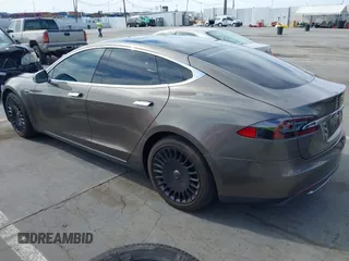 2015 Tesla Model S 85 with VIN 5YJSA1E14FF120455, listed as a IAAI auction lot 42053306 with 62,817 mi miles and . Bid and sale history available at DreamBid. Image 3.