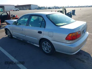 1999 Honda Civic EX with VIN JHMEJ8648XS000823, listed as a IAAI auction lot 41479594 with 299,294 mi miles. Bid and sale history available at carsss.com. Image 3.