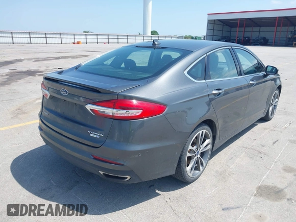 2020 Ford Fusion Titanium with VIN 3FA6P0D9XLR131042, listed as a IAAI auction lot 42560444 with 95,351 mi miles and . Bid and sale history available at DreamBid. Image 4.