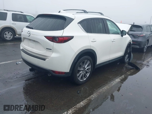 2020 Mazda CX-5 Grand Touring with VIN JM3KFBDMXL0785865, listed as a IAAI auction lot 41567177 with 64,519 mi miles. Bid and sale history available at carsss.com. Image 4.