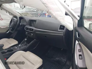 2016 Mazda CX-5 Grand Touring z VIN JM3KE2DY8G0885006, wystawiony jako IAAI lot #41615873 z przebiegiem 118 890 mil mil oraz . Historia ofert i sprzedaży dostępna na DreamBid. Obrazek 5.