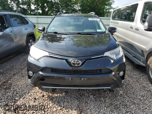 2018 Toyota RAV4 XLE with VIN 2T3RFREV0JW765995, listed as a Copart auction lot 63968785 with 114,598 mi miles and Salvage title. Bid and sale history available at DreamBid. Image 5.