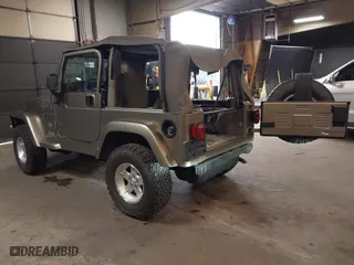 2004 Jeep Wrangler Sahara with VIN 1J4FA59S64P736389, listed as a IAAI auction lot 41432819 with 102,830 mi miles. Bid and sale history available at carsss.com. Image 3.