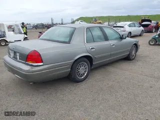 1999 Ford Crown Victoria LX with VIN 2FAFP74W4XX192490, listed as a IAAI auction lot 41791909 with 115,469 mi miles. Bid and sale history available at carsss.com. Image 4.