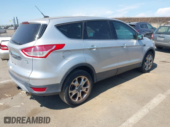 2013 Ford Escape SEL z VIN 1FMCU9H95DUC87631, wystawiony jako IAAI lot #42564756 z przebiegiem 144 467 mil mil oraz . Historia ofert i sprzedaży dostępna na DreamBid. Obrazek 4.
