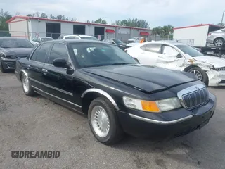 1999 Mercury Grand Marquis LS z VIN 2MEFM75W8XX645350, wystawiony jako IAAI lot #40713217 z przebiegiem 56 271 mil mil oraz . Historia ofert i sprzedaży dostępna na DreamBid. Obrazek 1.