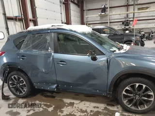2016 Mazda CX-5 Grand Touring z VIN JM3KE4DY9G0714468, wystawiony jako IAAI lot #41860956 z przebiegiem 114 481 mil mil oraz . Historia ofert i sprzedaży dostępna na DreamBid. Obrazek 13.