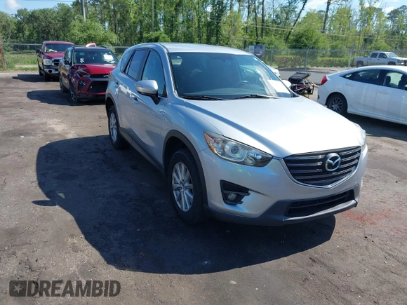 2016 Mazda CX-5 Touring z VIN JM3KE4CY4G0646114, wystawiony jako IAAI lot #42269181 z przebiegiem 58 252 mil mil oraz . Historia ofert i sprzedaży dostępna na DreamBid. Obrazek 1.
