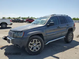 2004 Jeep Grand Cherokee Laredo with VIN 1J4GW48J74C197698, listed as a Copart auction lot 58597135 with 230,238 mi miles and Salvage title. Bid and sale history available at DreamBid. Image 1.