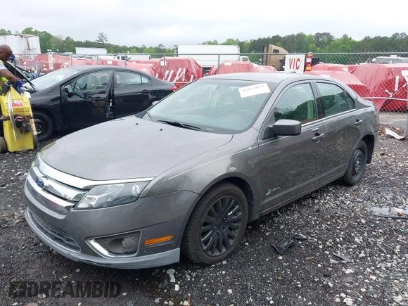 2011 Ford Fusion Hybrid z VIN 3FADP0L32BR238153, wystawiony jako IAAI lot #42113064 z przebiegiem 145 932 mil mil oraz . Historia ofert i sprzedaży dostępna na DreamBid. Obrazek 2.