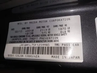 2015 Mazda 3 i Touring with VIN JM1BM1L75F1259985, listed as a IAAI auction lot 41067447 with 104,865 mi miles and . Bid and sale history available at carsss.com. Image 9.