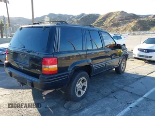 1998 Jeep Grand Cherokee Limited with VIN 1J4GX78Y8WC110325, listed as a IAAI auction lot 41357373 with 165,106 mi miles. Bid and sale history available at carsss.com. Image 4.
