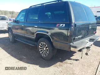 1999 GMC Yukon with VIN 1GKEK13R4XJ762708, listed as a IAAI auction lot 41653291 with 200,240 mi miles. Bid and sale history available at carsss.com. Image 3.