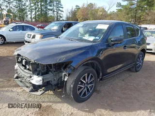 2018 Mazda CX-5 Touring z VIN JM3KFACM0J1389057, wystawiony jako IAAI lot #40922679 z przebiegiem 140 026 mil mil oraz . Historia ofert i sprzedaży dostępna na DreamBid. Obrazek 2.