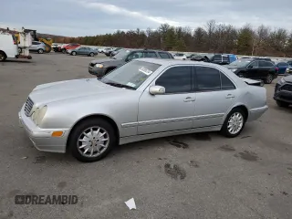 2000 Mercedes-Benz E-Class with VIN WDBJF65J8YB153103, listed as a Copart auction lot 80986234 with 144,205 mi miles and Salvage Title. Bid and sale history available at carsss.com. Image 1.