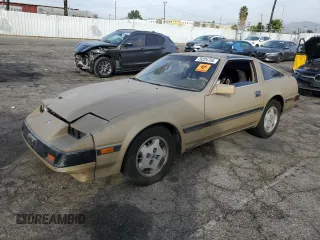 1985 Nissan 300ZX z VIN JN1HZ14S5FX091697, wystawiony jako Copart lot #79224754 z przebiegiem 189 999 mil mil oraz Szkoda całkowita • Salvage title. Historia ofert i sprzedaży dostępna na DreamBid. Obrazek 1.