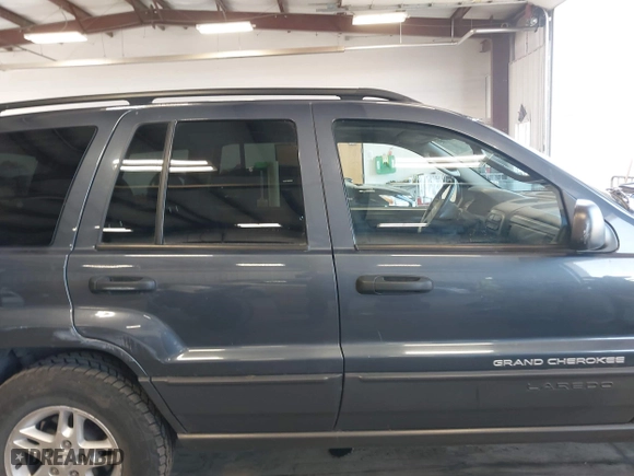 2003 Jeep Grand Cherokee Laredo with VIN 1J4GW48S33C539977, listed as a IAAI auction lot 42027703 with 100,534 mi miles. Bid and sale history available at carsss.com. Image 14.