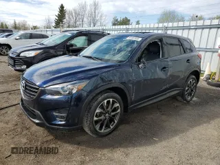 2016 Mazda CX-5 Grand Touring z VIN JM3KE4DYXG0825806, wystawiony jako Copart lot #55307055 z przebiegiem 86 953 mil mil oraz Czysty tytuł • Clean title. Historia ofert i sprzedaży dostępna na DreamBid. Obrazek 1.