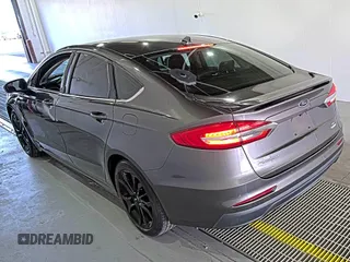2020 Ford Fusion SE z VIN 3FA6P0HD6LR189762, wystawiony jako IAAI lot #42780149 z przebiegiem 51 099 mil mil oraz . Historia ofert i sprzedaży dostępna na DreamBid. Obrazek 3.