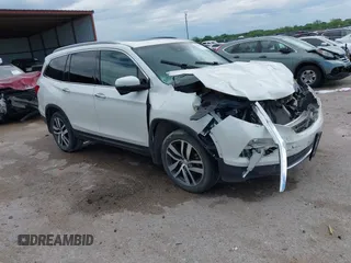 2017 Honda Pilot Touring z VIN 5FNYF6H9XHB034001, wystawiony jako IAAI lot #42092549 z przebiegiem 142 422 mil mil oraz . Historia ofert i sprzedaży dostępna na DreamBid. Obrazek 1.