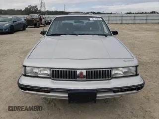 1992 Oldsmobile Cutlass z VIN 1G3AL54N7N6363365, wystawiony jako Copart lot #76144254 z przebiegiem 52 896 mil mil oraz Tytuł czysty. Historia ofert i sprzedaży dostępna na DreamBid. Obrazek 5.