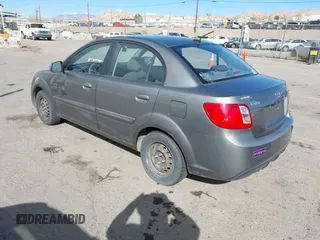 2010 Kia Rio LX with VIN KNADH4A34A6674027, listed as a IAAI auction lot 41804686 with 113,528 mi miles. Bid and sale history available at carsss.com. Image 3.