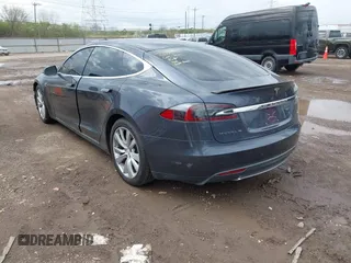 2015 Tesla Model S 85D with VIN 5YJSA1E21FF116775, listed as a IAAI auction lot 41876772 with 128,805 mi miles. Bid and sale history available at carsss.com. Image 3.