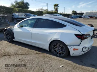 2020 Tesla Model 3 Standard Range Plus with VIN 5YJ3E1EA0LF808571, listed as a Copart auction lot 47827615 with 125,444 mi miles and Salvage Title. Bid and sale history available at DreamBid. Image 2.