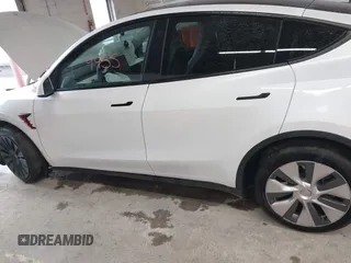 2023 Tesla Model Y Long Range with VIN 7SAYGDEE7PA100523, listed as a IAAI auction lot 40399455 with 18,885 mi miles and . Bid and sale history available at DreamBid. Image 14.