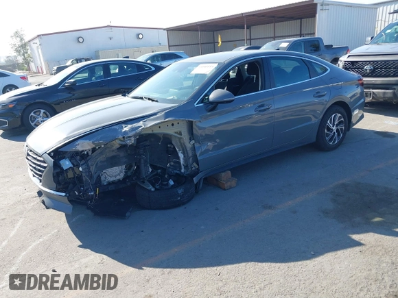 2022 Hyundai Sonata Hybrid Blue with VIN KMHL24JJ1NA041773, listed as a IAAI auction lot 41043553 with 23,696 mi miles. Bid and sale history available at carsss.com. Image 2.