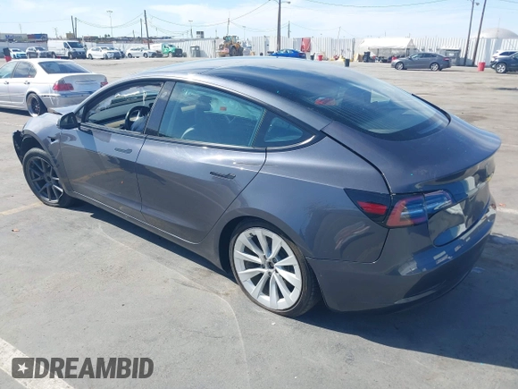 2022 Tesla Model 3 with VIN 5YJ3E1EA1NF142713, listed as a IAAI auction lot 42027630 with 112,557 mi miles. Bid and sale history available at carsss.com. Image 3.
