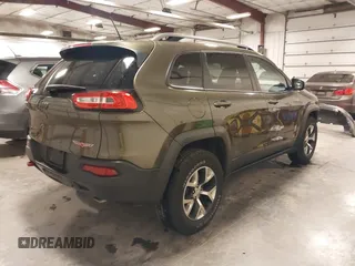 2015 Jeep Cherokee Trailhawk with VIN 1C4PJMBSXFW563144, listed as a IAAI auction lot 40667962 with 121,536 mi miles. Bid and sale history available at carsss.com. Image 4.
