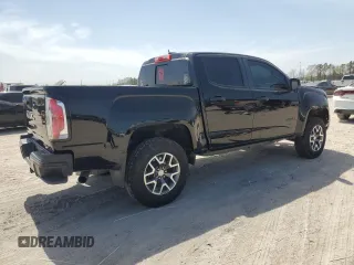 2021 GMC Canyon 4WD AT4 w/Leather with VIN 1GTG6FEN3M1274409, listed as a Copart auction lot 49228145 with 57,194 mi miles and Salvage Title. Bid and sale history available at carsss.com. Image 3.