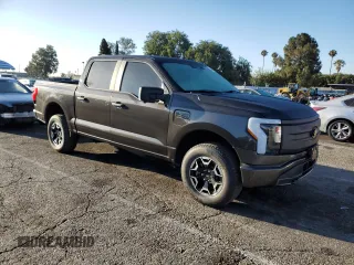 2023 Ford F-150 Lightning Pro with VIN 1FTVW1EL7PWG11261, listed as a Copart auction lot 64088925 with 3,288 mi miles and Salvage title. Bid and sale history available at DreamBid. Image 4.