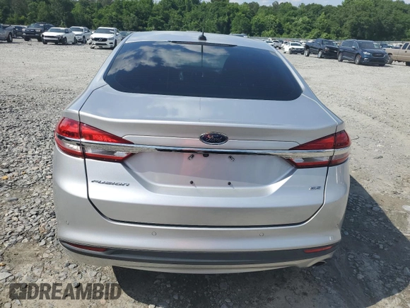2017 Ford Fusion SE z VIN 3FA6P0H74HR164747, wystawiony jako Copart lot #56139855 z przebiegiem 105 769 mil mil oraz Szkoda całkowita • Salvage title. Historia ofert i sprzedaży dostępna na DreamBid. Obrazek 6.