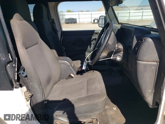 2006 Jeep Wrangler Sport Right Hand Drive with VIN 1J4F449S76P747454, listed as a Copart auction lot 77819214 with 184,763 mi miles and Salvage Title. Bid and sale history available at carsss.com. Image 7.