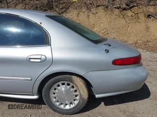 1999 Mercury Sable LS z VIN 1MEFM53S7XA622932, wystawiony jako IAAI lot #41708531 z przebiegiem 155 702 mil mil oraz . Historia ofert i sprzedaży dostępna na DreamBid. Obrazek 13.