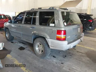 1996 Jeep Grand Cherokee Laredo with VIN 1J4GZ58S9TC293787, listed as a IAAI auction lot 41179368 with 141,755 mi miles. Bid and sale history available at carsss.com. Image 3.