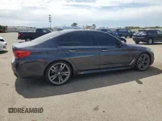 2018 BMW 5 Series M550i xDrive with VIN WBAJB9C57JB286734, listed as a Copart auction lot 52711235 with 127,450 mi miles and Salvage title. Bid and sale history available at DreamBid. Image 3.