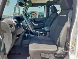 2014 Jeep Wrangler Unlimited Sahara with VIN 1C4BJWEG5EL309502, listed as a Copart auction lot 61804885 with 60,683 mi miles and Salvage title. Bid and sale history available at DreamBid. Image 7.