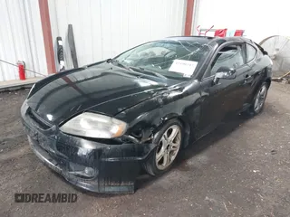 2005 Hyundai Tiburon GT z VIN KMHHN65F45U184777, wystawiony jako IAAI lot #42190342 z przebiegiem 213 013 mil mil oraz . Historia ofert i sprzedaży dostępna na DreamBid. Obrazek 2.