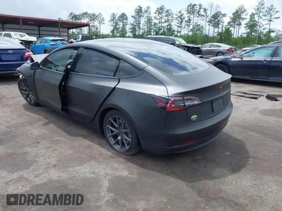 2022 Tesla Model 3 with VIN 5YJ3E1EA3NF287512, listed as a IAAI auction lot 42000557 with 77,619 mi miles. Bid and sale history available at carsss.com. Image 3.