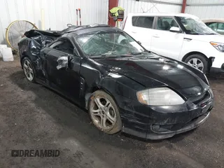 2005 Hyundai Tiburon GT z VIN KMHHN65F45U184777, wystawiony jako IAAI lot #42190342 z przebiegiem 213 013 mil mil oraz . Historia ofert i sprzedaży dostępna na DreamBid. Obrazek 1.