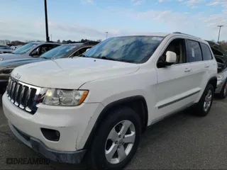 2011 Jeep Grand Cherokee Laredo with VIN 1J4RR4GG1BC669834, listed as a IAAI auction lot 42019804 with 173,943 mi miles. Bid and sale history available at carsss.com. Image 2.