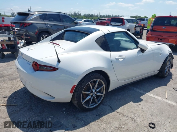 2021 Mazda MX-5 Miata Grand Touring z VIN JM1NDAM75M0450871, wystawiony jako IAAI lot #42060495 z przebiegiem 48 670 mil mil oraz . Historia ofert i sprzedaży dostępna na DreamBid. Obrazek 4.