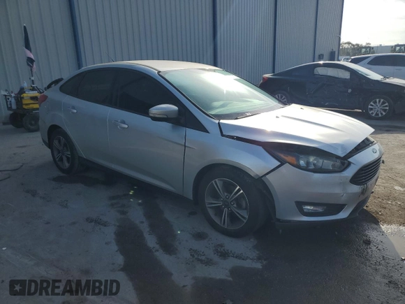 2017 Ford Focus SE with VIN 1FADP3FE9HL273889, listed as a Copart auction lot 53737055 with 114,700 mi miles and Salvage Title. Bid and sale history available at DreamBid. Image 4.