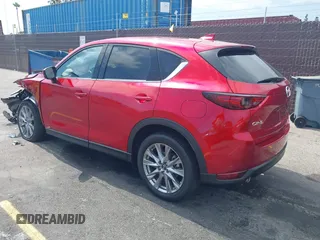 2021 Mazda CX-5 Grand Touring with VIN JM3KFADM6M1373111, listed as a IAAI auction lot 42784431 with 14,374 mi miles and . Bid and sale history available at DreamBid. Image 3.