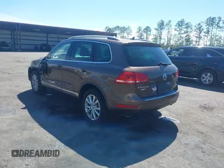 2014 Volkswagen Touareg Sport with VIN WVGEF9BP7ED003525, listed as a IAAI auction lot 41868307 with 74,379 mi miles and . Bid and sale history available at DreamBid. Image 3.