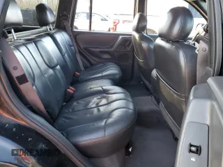 1999 Jeep Grand Cherokee Laredo z VIN 1J4GW58N1XC737706, wystawiony jako Copart lot #83107914 z przebiegiem Nie podano mil oraz Szkoda całkowita • Salvage title. Historia ofert i sprzedaży dostępna na DreamBid. Obrazek 12.