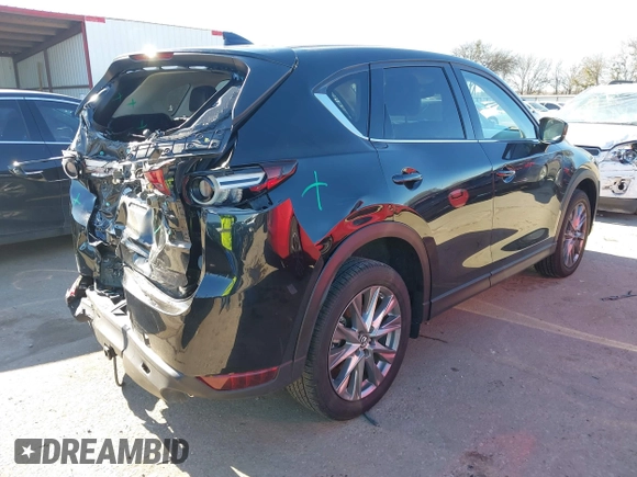 2021 Mazda CX-5 Grand Touring with VIN JM3KFADM1M0406098, listed as a IAAI auction lot 41654735 with 33,050 mi miles. Bid and sale history available at carsss.com. Image 4.